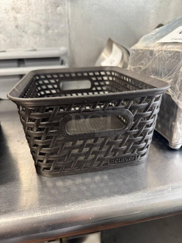 Lot of 4 small black plastic weave bins, brand Curver, rectangular with handle slots, in good condition.
