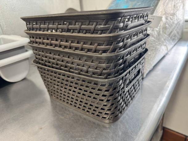 Lot of 4 small plastic weave bins, stacked, uniform brown color, with handles, good condition, ideal for storage.