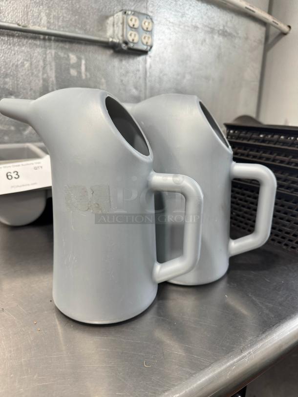 Lot of 2 gray funnel cake batter pouring pitchers with spouts and handles. Good condition, perfect for kitchen use.