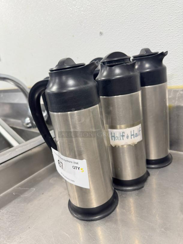 Stainless steel cream server BIDX5, black lid and handle, good condition, sticker marked "Half & Half," another with auction details.