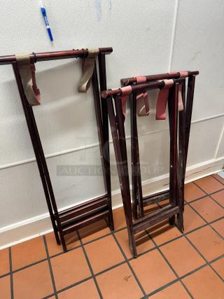 Folding wood tray stands, dark finish, with fabric straps. In good condition, suitable for supporting trays.