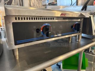 Star Max 24" natural gas commercial griddle; stainless steel, control knobs visible, slight wear, "Caution" label affixed.