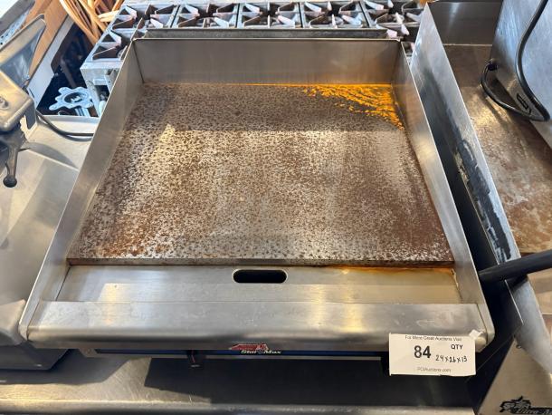 Star Max 24" natural gas commercial griddle, used condition, visible rust on cooking surface, label indicating model and dimension.