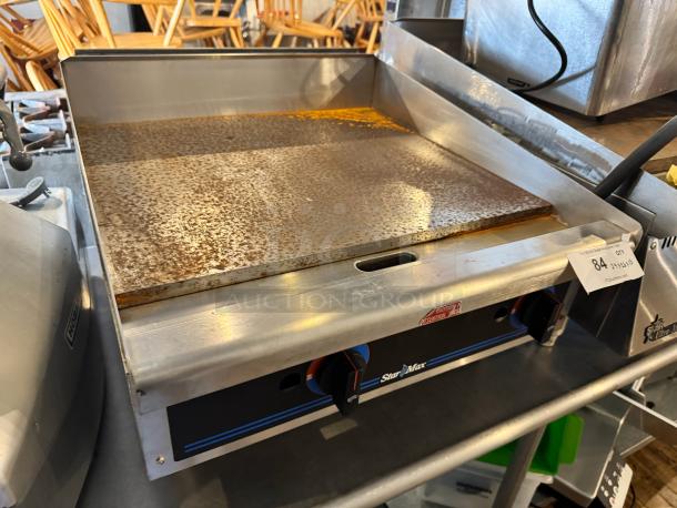 Star Max 24" natural gas commercial griddle, used condition, stainless steel, dual control knobs, Item #84 visible.