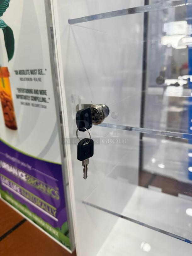 Acrylic Display Cabinet BIDX3 with lock and keys, clear shelves, pristine condition, ideal for showcasing collectibles.