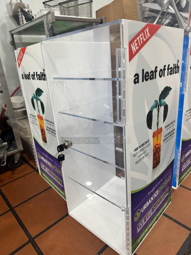 Acrylic Display Cabinet BIDX3 with clear shelves, Netflix branding "a leaf of faith" on sides, secure lock, excellent condition.