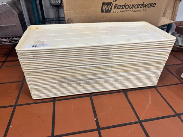 Long plastic display tray, model BIDX32, stacked and ribbed design. Shows moderate wear, labeled "92" for auction.