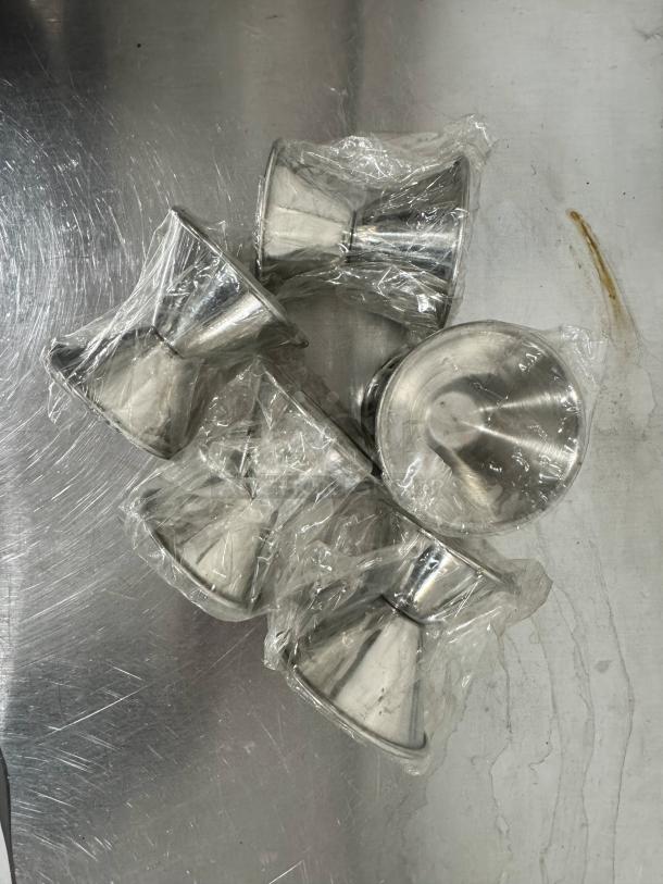 Lot of 5 stainless steel double jiggers, new in packaging, no visible markings, ideal for bartending.