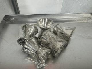 Lot of 5 stainless steel double jiggers, new condition, individually wrapped, ideal for precise cocktail measuring.