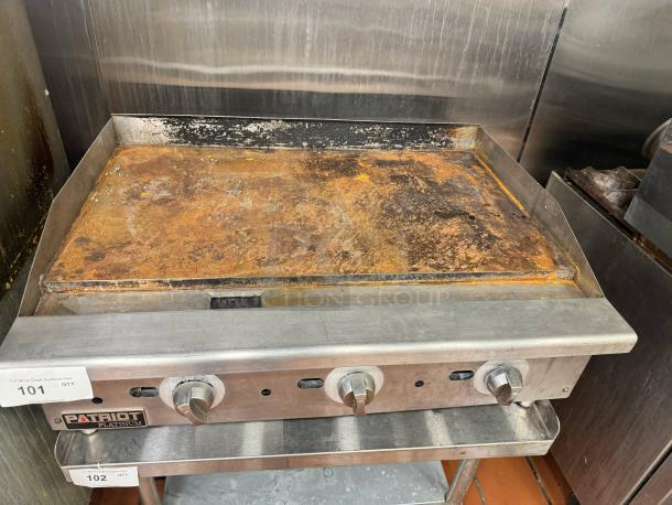 PATRIOT PLATINUM 36" natural gas griddle with visible wear. Includes control knobs and brand label. Stand not included.