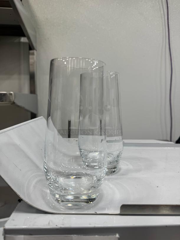 Clear highball glass BIDX19, sleek design, cylindrical shape, excellent condition, ideal for cocktails or beverages.