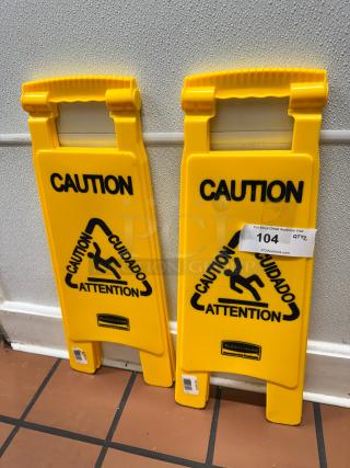 Yellow Rubbermaid Commercial Products floor signs with "Caution" text in multiple languages, in good condition.