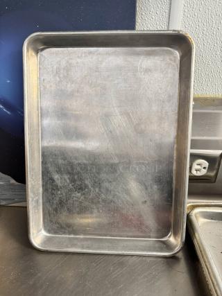 Half-size aluminum baking sheet BIDX10, shows minor scratches, in good condition, ideal for versatile kitchen use.