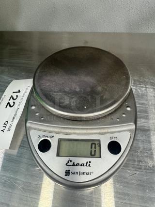 San Jamar Digital Scale, silver, LCD display showing 0g, on/tare button, in used condition, ideal for precise measurements.