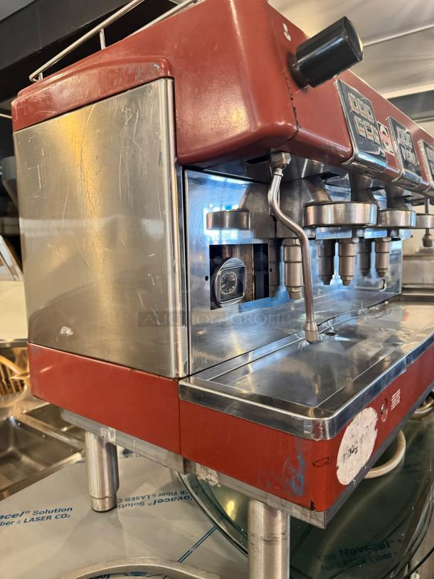 BRASILIA 205EX FNC DIG 3 Espresso machine, red, stainless steel panels, slight wear, with control panel and steam wands visible.