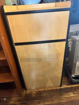 Wooden gallon waste receptacle with black trim, standing against a wooden floor. Excellent condition.