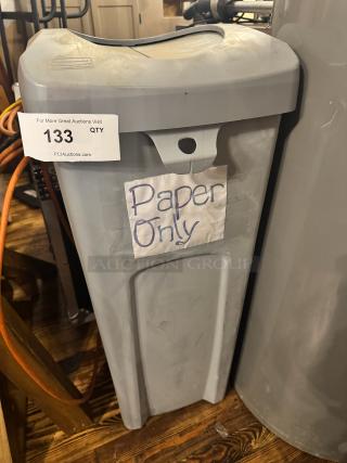 Rubbermaid trash can in gray, marked "Paper Only," with lid and visible auction tag #133. Good condition.