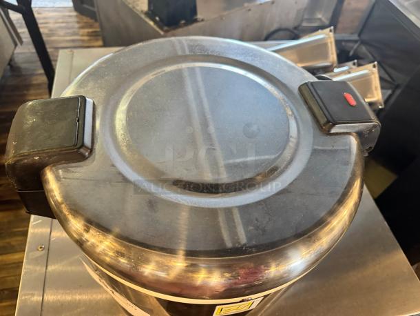 Stainless steel rice warmer, 50-cup capacity, sturdy lid handles, slight surface wear, ideal for large servings.