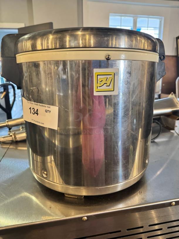 Stainless steel rice warmer for 50 cups, features brand logo and a label with "134 QTY," showing moderate wear.