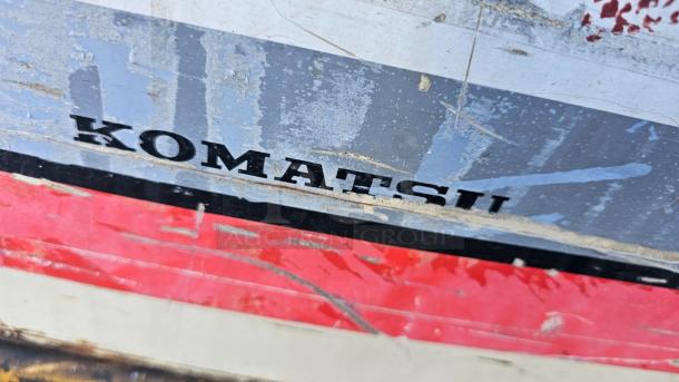 KOMATSU FG 15ST-2 forklift detail, showcasing the brand name on a worn surface. Forklift in good working condition.