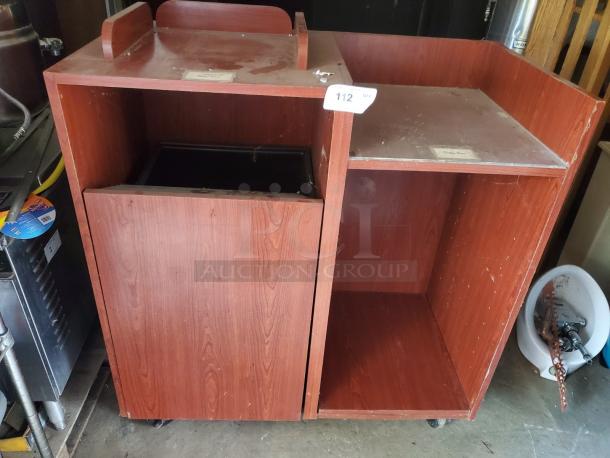 Wooden tray top receptacle with two compartments, showing moderate wear. Features a label and unit number "112".