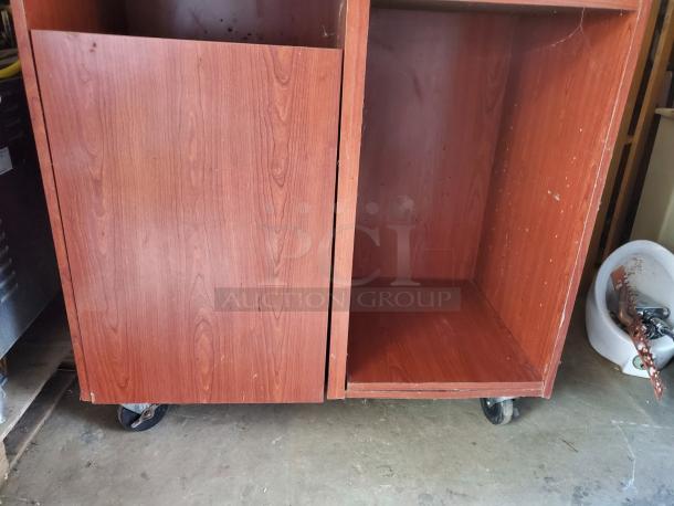 Wood top tray receptacle with a sturdy wooden construction. Features open storage space, caster wheels, and visible wear.