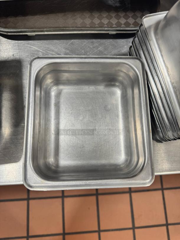 Stainless steel food pan BIDX10, square shape, stackable, used condition with minor surface scratches.