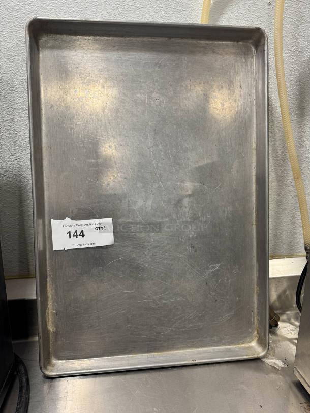 Full-size baking pan BIDX5, metal, used condition with visible scratches. Auction label shows item number 144, quantity 5.