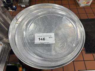 Set of 4 metal pizza pans, used condition, label showing auction lot number 146 from PCI Auctions.