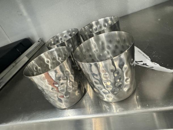 Lot of 4 stainless steel French fry holders with hammered texture on a metal surface. Appears in good condition.