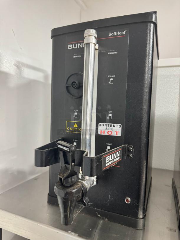 BUNN SoftHeat 1.5 Gallon Portable Server BIDX2, black, with dispensing spout, caution labels, and capacity indicators.