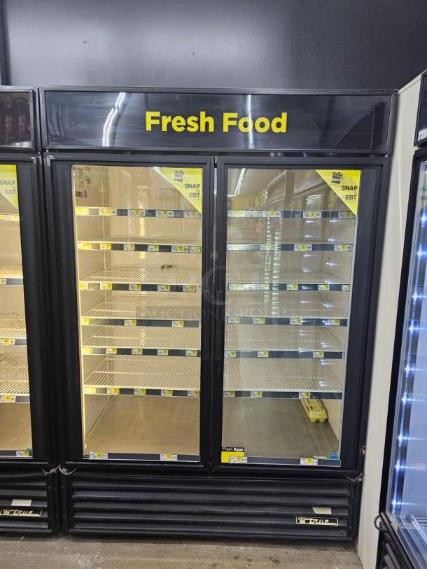 TRUE GDM-49 glass door merchandiser refrigerator, tested and working, two-section, visible "Fresh Food" sign, black trim.