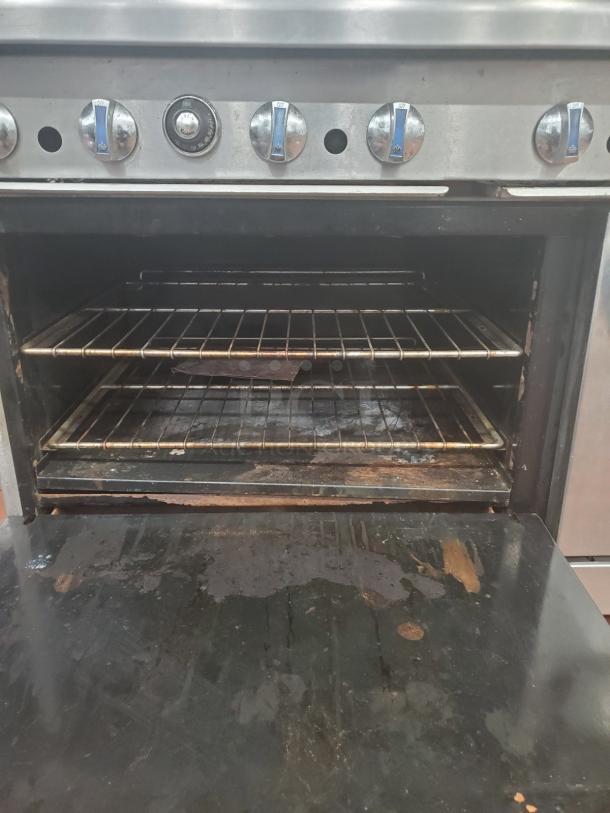 Imperial NG 10 Burner Stove with 2 ovens, featuring control knobs and spacious interior. Moderate wear visible.