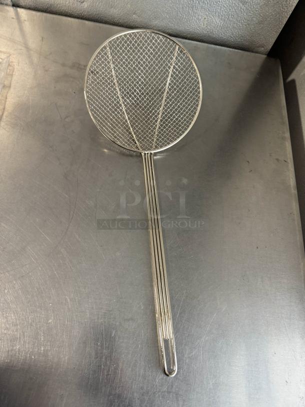 8" round wire skimmer with a long handle, silver-colored metal, features a mesh basket, excellent condition.