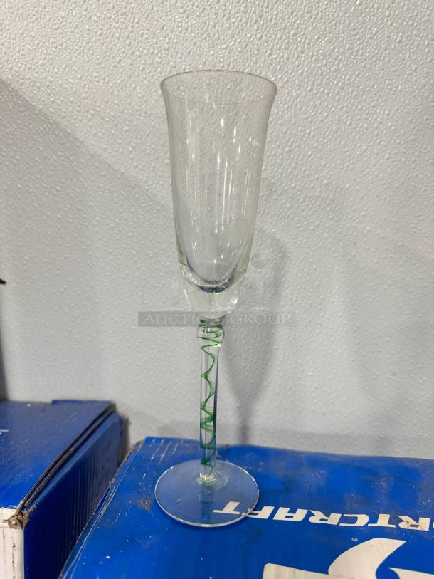 Elegant Champagne flute BIDX16, featuring a green spiral stem design. Excellent condition, clear glass.