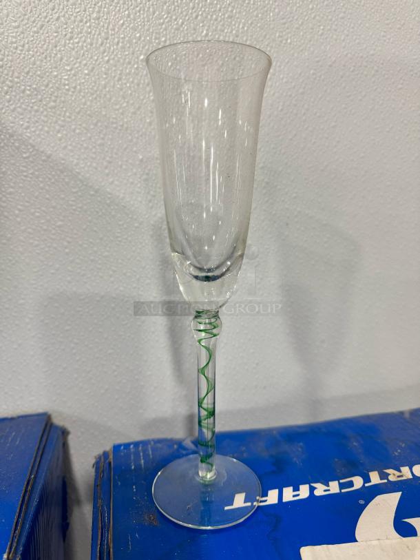 Champagne flute BIDX16, clear glass with a green spiral stem. Excellent condition, elegant design, ideal for collectors.