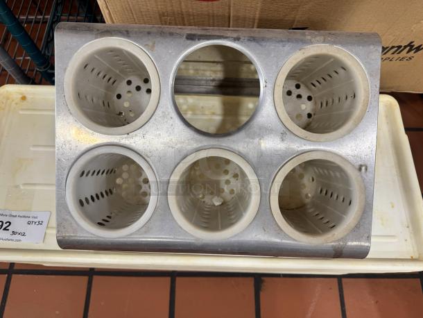 Six-hole stainless steel flatware organizer with five perforated plastic cylinders, one missing. Used condition.