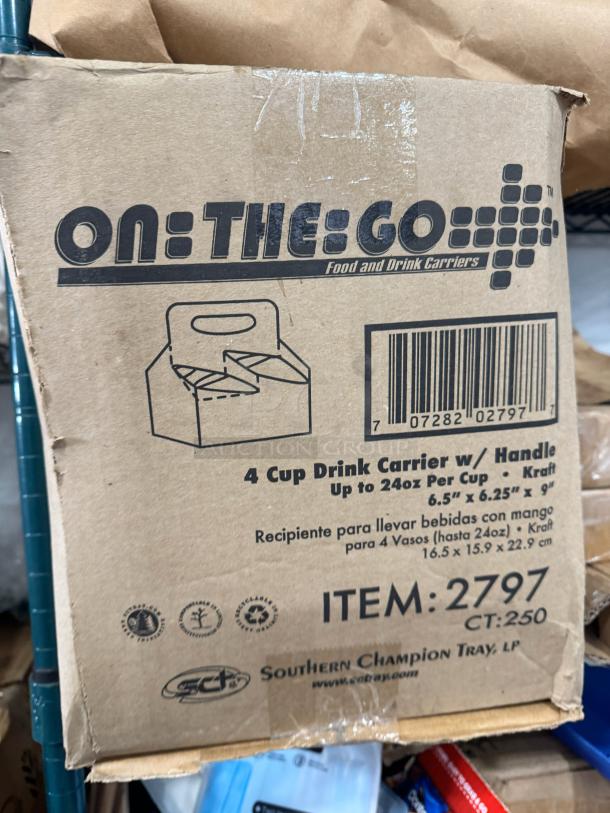 Box labeled "On-The-Go" containing 4 cup drink carriers with handles. Item #2797, fits up to 24oz cups, dimensions 6.5"x6.25"x9".