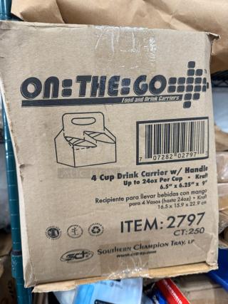 Box labeled "On-The-Go" containing 4 cup drink carriers with handles. Item #2797, fits up to 24oz cups, dimensions 6.5"x6.25"x9".