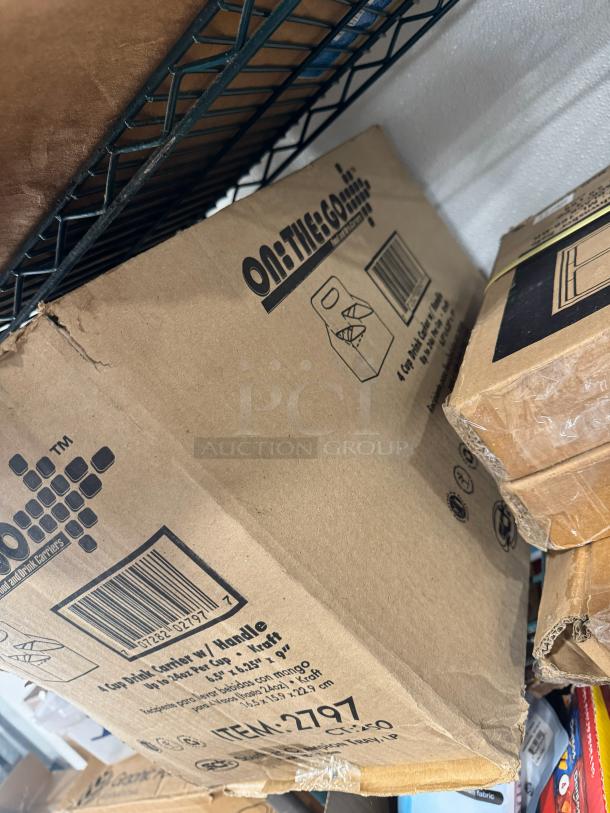 Full box of "On the Go" 4 Cup Drink Carriers with handle, item 2797, sealed in original cardboard packaging.