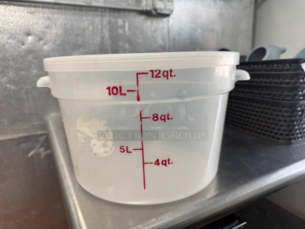12qt round food storage container with red measurement markings for quarts and liters. Slight wear visible on surface.