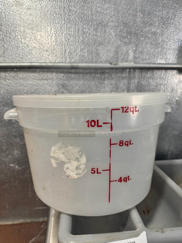 12qt round food storage container with red measurements, visible wear and label residue, suitable for kitchen storage.