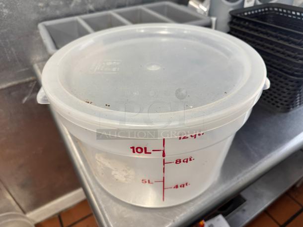 12qt round food storage container with lid, marked in quarts and liters, minor surface wear, ideal for kitchen use.
