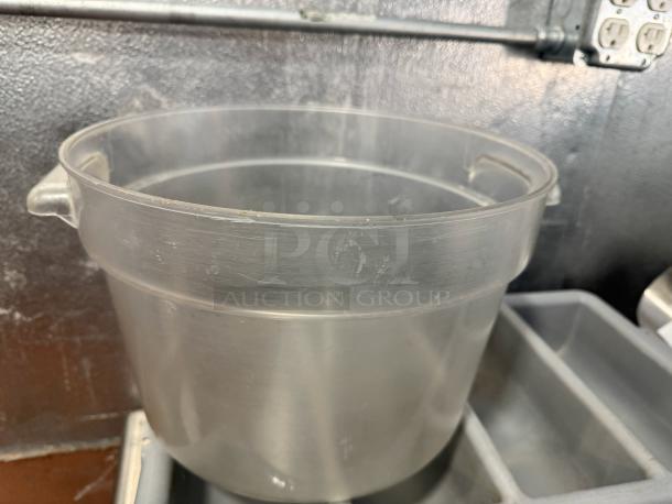 12qt round food storage container, clear plastic, with dual handles. Used condition with surface wear.