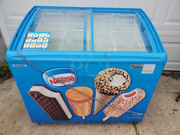 AHT RIO S 100 ice cream freezer merchandiser, blue with Nestle branding, dual sliding glass doors, used condition.
