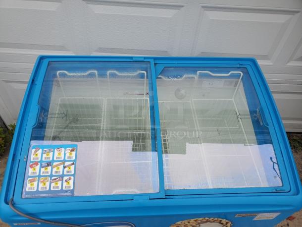 AHT RIO S 100 ice cream freezer merchandiser with dual sliding glass lids, blue exterior, and interior wire baskets.