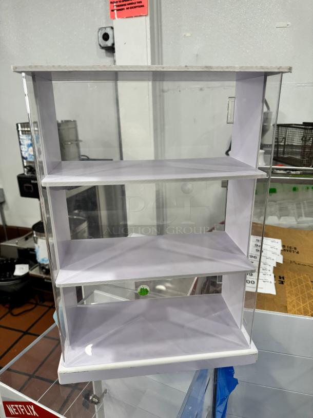 Clear acrylic display cabinet with three shelves, in good condition, ideal for showcasing items. Measures approximately 24x12x30 inches.