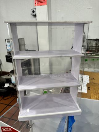 Clear acrylic display cabinet with three shelves, in good condition, ideal for showcasing items. Measures approximately 24x12x30 inches.