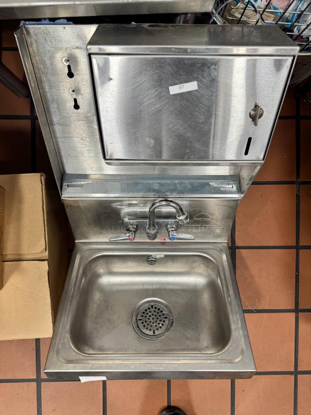 ADVANCE TABCO stainless steel wall-mounted hand sink with faucet, soap, and fold paper towel dispenser, used, model number not shown.