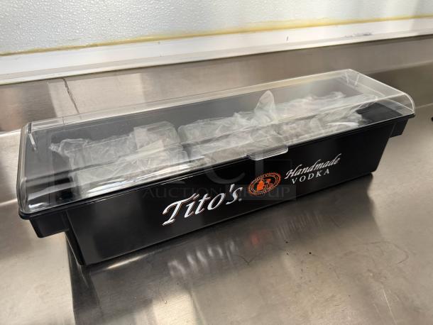 Black Tito's Vodka condiment tray, brand new, with clear lid. Features logo and text "Handmade Vodka" on the side.